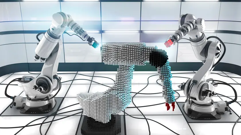 Two robots build the third, stylised prototype in a light, clinical laboratory