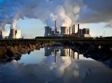 epa07208455 Steam rises from the brown coal-fired power plant Neurath (C) and Niederaussem (L) operated by RWE in Bergheim, 04 December 2018. The Rhenish Brown Coal Field is Europe's largest carbon dioxide source. According to a report by the UN, the carbon dioxide (CO2) emissions have gone up for the first time in four years. The report came just days ahead of the COP24 United Nations Climate Change Conference taking place in Poland from 02 to 14 December 2018. EPA/SASCHA STEINBACH