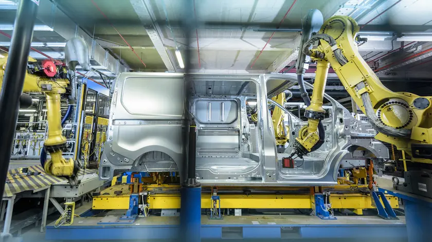 Vehicle and robots on production line in car factory