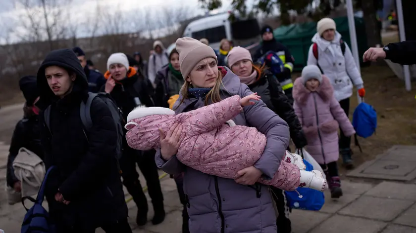 Refugees fleeing war in neighboring Ukraine arrive at the Medyka crossing border, Poland, Thursday, March 10, 2022. (AP Photo/Daniel Cole)