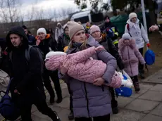 Refugees fleeing war in neighboring Ukraine arrive at the Medyka crossing border, Poland, Thursday, March 10, 2022. (AP Photo/Daniel Cole)