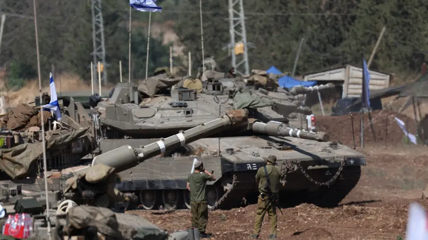 epa11633443 Israeli soldiers check military vehicles at a gathering site next to the border with Lebanon as seen from an undisclosed location in northern Israel, 30 September 2024. The Israeli military announced on 30 September that it had eliminated the head of the Lebanon Branch of Hamas during an ‘overnight joining IDF and ISA intelligence-based’ operation in Lebanon.