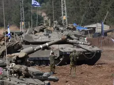 epa11633443 Israeli soldiers check military vehicles at a gathering site next to the border with Lebanon as seen from an undisclosed location in northern Israel, 30 September 2024. The Israeli military announced on 30 September that it had eliminated the head of the Lebanon Branch of Hamas during an ‘overnight joining IDF and ISA intelligence-based’ operation in Lebanon.