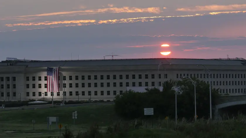 epa05534756 A handout image issued by US Navy, showing the sunrise early 11 September 2016 at the Pentagon prior to a ceremony to commemorate the 15th anniversary of the Sept. 11, 2001 terror attacks. The American flag is draped over the site of impact at the Pentagon. In 2008, the National 9/11 Pentagon Memorial opened adjacent to the site, located on Boundary Channel Drive in Arlington, Va., and commemorates the 184 lives lost at the Pentagon and onboard American Airlines Flight 77 during the terrorist attacks. EPA/DAMON MORITZ / HANDOUT