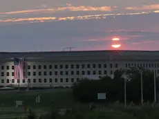 epa05534756 A handout image issued by US Navy, showing the sunrise early 11 September 2016 at the Pentagon prior to a ceremony to commemorate the 15th anniversary of the Sept. 11, 2001 terror attacks. The American flag is draped over the site of impact at the Pentagon. In 2008, the National 9/11 Pentagon Memorial opened adjacent to the site, located on Boundary Channel Drive in Arlington, Va., and commemorates the 184 lives lost at the Pentagon and onboard American Airlines Flight 77 during the terrorist attacks. EPA/DAMON MORITZ / HANDOUT