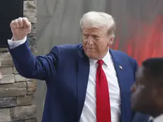 epa11642584 Former US president and Republican presidential nominee Donald Trump gestures after speaking to the news media with Georgia Governor Brian Kemp (not pictured) in the wake of damage and recovery from Hurricane Helene in Evans, Georgia, USA, 04 October 2024. The Augusta area suffered major damage after Helene swept through. Trump is running against Democratic US Vice President Kamala Harris. EPA/ERIK S. LESSER