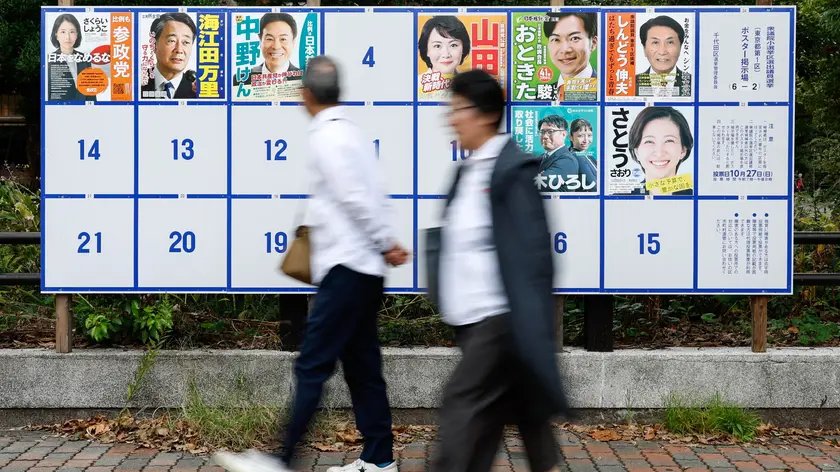 epa11682172 People walk in front of a board displaying campaign posters of candidates running for the upcoming general elections in Tokyo, Japan, 25 October 2024. Shortly after being elected as Japan’s Prime Minister, Ishiba Shigeru dissolved the parliament and called for elections of the House of Representatives, the lower house of Japan's National Diet. Set for 27 October, the vote will follow a 12-day campaign amid scandals involving the ruling Liberal Democratic Party (LDP), a sluggish economy and rising consumer prices, according to the European Parliament Think Tank. EPA/FRANCK ROBICHON