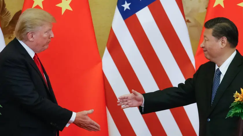 epa06316948 US President Donald J. Trump (L) and Chinese President Xi Jinping (R) shake hands during a press conference at the Great Hall of the People (GHOP) in Beijing, China, 09 November 2017. Trump is on an official visit to China from 08 to 10 November as part of his 12-day tour of Asia. EPA/ROMAN PILIPEY