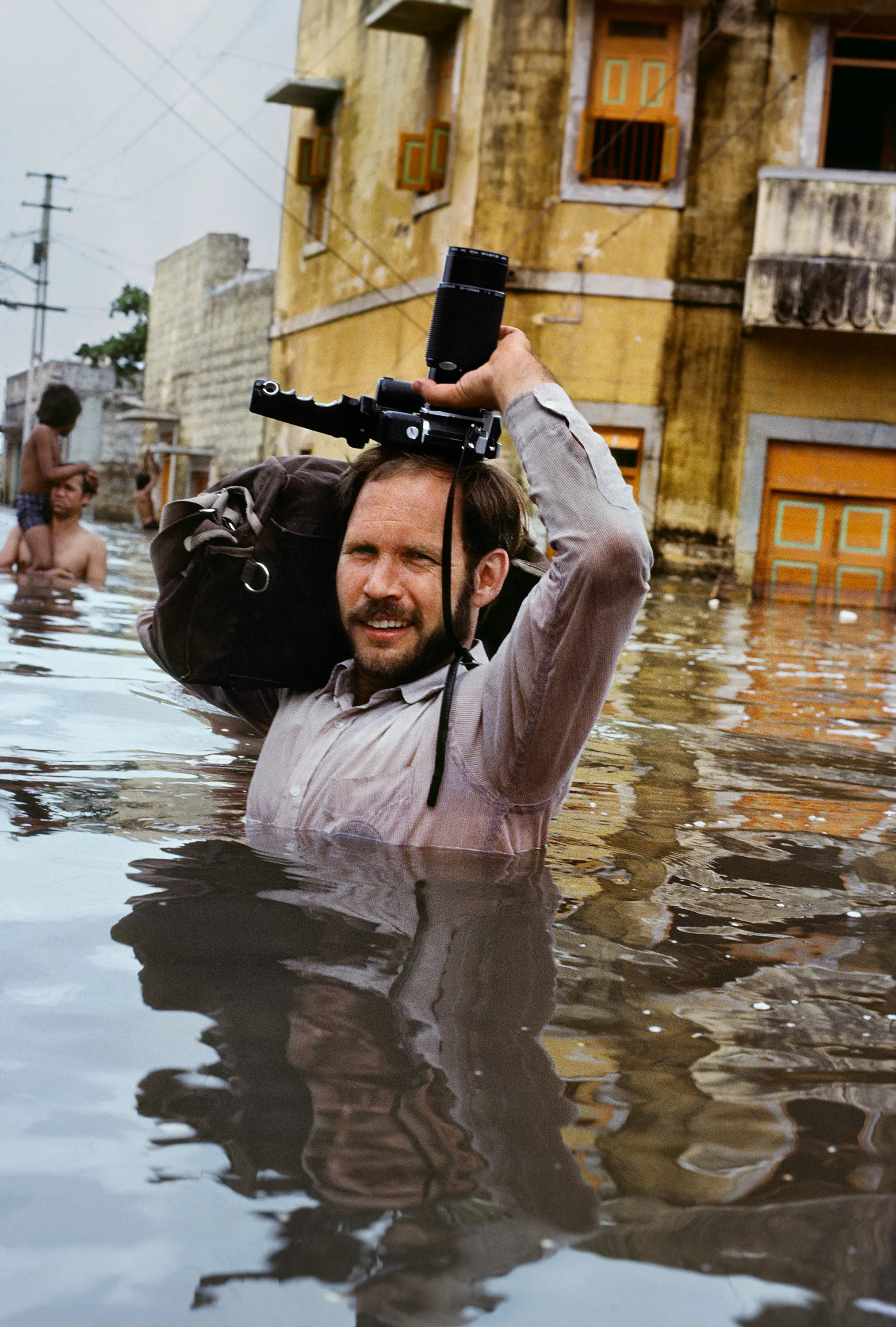 00011_08, Porbander, Gujarat, India, July, 1983. CAPTION: Porbandar, Gujarat, India, 1983. Steve McCurry in monsoon floods, Porbandar, India, 1983. pg 2 Untold, The Stories Behind the Photographs. Retouched_ Sonny Fabbri, Sam Wallander 5/16/2018 Untold_book Book_Riotta Biography 2016 Bonnie Book FINAL SELECT