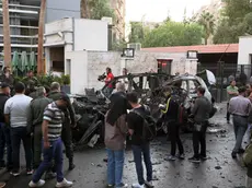 epa11673481 Syrian soldiers and civilians inspect the site of an airstrike that targeted a vehicle in the Al-Mazzeh neighborhood in Damascus, Syria, 21 October 2024. At least two people were killed and three others were injured in the Israeli airstrike, according to Syrian state news agency SANA quoting military sources. EPA/STR