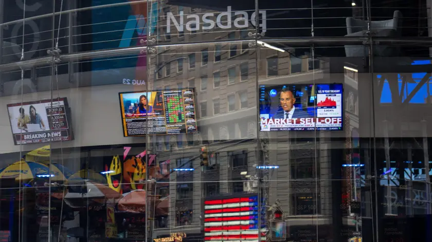 epa11528584 People walk past the Nasdaq in New York, USA, 05 August 2024. US indexes dropped at opening as stock markets around the world are declining from large sell-offs while investors continue to react to a report released last week by the United States Bureau of Labor Statistics showing the unemployment rate in the United States rose to 4.3 percent in July 2024. EPA/JOHN TAGGART