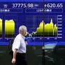 epa11615145 A passerby walks past a stock market indicator board in Tokyo, Japan, 20 September 2024. Tokyo stocks rose following optimism in the US economy and as the Bank of Japan decided to keep its interest rate unchanged after a two-day policy meeting. The 225-issue Nikkei Stock Average gained 568.58 points, or 1.53 percent, to close the week at 37,723.91. EPA/FRANCK ROBICHON