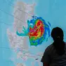 epa11714149 A weather unit supervisor of the Quezon City Disaster Risk Reduction and Management Office (QCDRRMO) looks at an electronic screen projecting the track of Typhoon Toraji at a monitoring center in Quezon City, Metro Manila, Philippines, 11 November 2024. Schools in Metro Manila suspended classes, and citizens were reminded to take necessary precautions as Typhoon Toraji struck the Northern Luzon region, bringing heavy rain and sustaining winds of 130 kilometers per hour. EPA/ROLEX DELA PENA