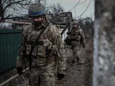 epa10507972 Ukrainian soldiers from the Volyn Detachment patrol the devastated town of Velyka Novosilka, Donetsk region, Ukraine, 07 March 2023. There are less than 500 people still living in the town, because the Russian positions are less than a kilometer away and the shelling is continuous. Russian troops entered Ukrainian territory on 24 February 2022, starting a conflict that has provoked destruction and a humanitarian crisis. EPA/MARIASENOVILLA