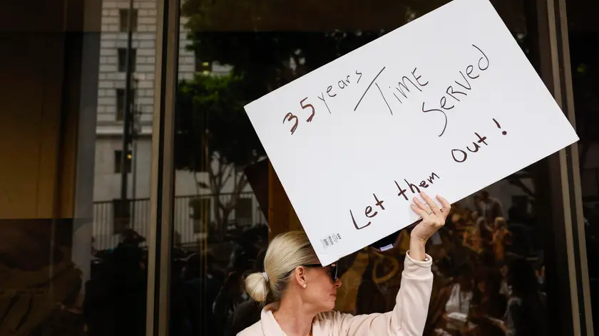 epa11663385 A person holds up a sign as family members of Erik and Lyle Menendez hold a news conference to call for their release from prison after the brothers were convicted in 1996 of first-degree murder for the 1989 shooting of their parents, Jose and Kitty Menendez, outside of the Clara Shortridge Foltz Criminal Justice Center in Los Angeles, California, USA, 16 October 2024. The Los Angeles County District Attorney's Office announced earlier this month at a news conference that they would be reevaluating the brothers' convictions. The brothers are currently serving life sentences in state prison without the possibility of parole. EPA/CAROLINE BREHMAN