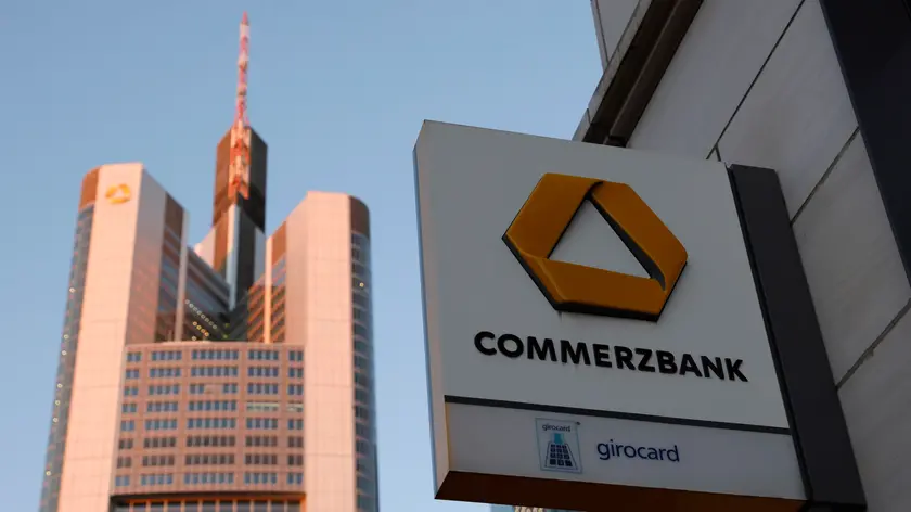 epa10493436 A exterior view of the German Commerzbank tower behind a bank braches logo in Frankfurt am Main, Germany, 27 February 2023. Commerzbank AG will return into the group of 40 businesses listed in German Stock Market Index DAX on 27 February. The bank lost its rank in the DAX in autumn 2018 due to severe loss in their stocks value. The bank, that was one of the founding businesses of the DAX, can now return due to the withdrawal of the Linde company from trading at the Franfurt Stock exchange, the 'Deutsche Boerse Group' said on their website. EPA/RONALD WITTEK