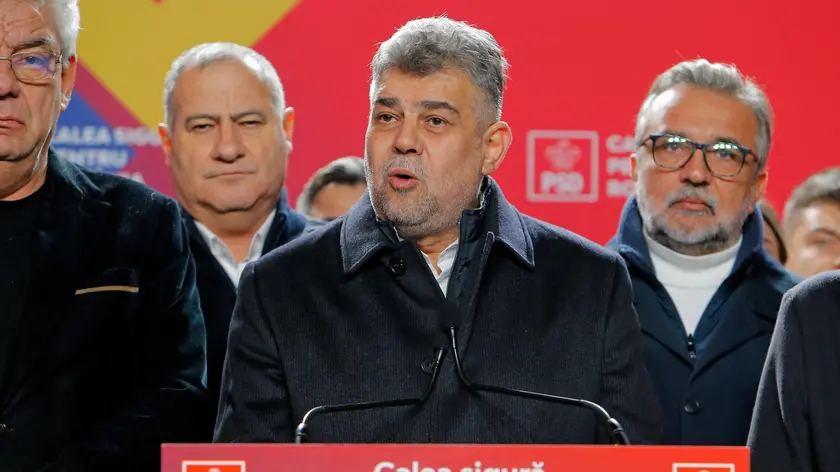 epa11738932 Prime minister Marcel Ciolacu (C), leader of the PSD (Social Democracy Party) party and presidential candidate delivers his speech at the PSD campaign headquarters after the first exit-poll, in Bucharest, Romania, 24 November 2024. According to the first exit-poll results, Social Democrat Prime Minister Marcel Ciolacu was leading with around 25 percent, while center-right politician Elena Lasconi of the Save Romania Union party, came in second and will likely face a run-off with Ciolacu on 08 December. Simion’s AUR won 15 percent of votes. EPA/BOGDAN CRISTEL