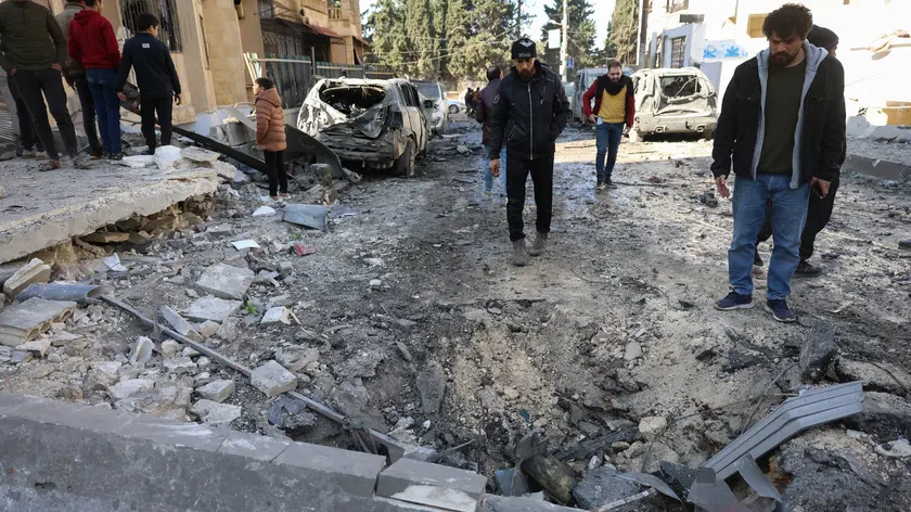 epaselect epa11751369 People inspect the damage after an airstrike in Idlib, northern Syria, 01 December 2024. According to the White Helmets, the Syrian civil group in northwestern Syria, at least eight people, including two children, were killed and 63 others injured in airstrikes carried out on residential neighborhoods in Idlib city. Syrian opposition forces led by the Islamist militant group Hayat Tahrir al-Sham (HTS) launched a large offensive on 27 November, taking large parts of Aleppo, the country's second-biggest city, triggering counterattacks by Syrian regime forces on opposition-controlled areas as well as Russian and Syrian airstrikes. EPA/MOHAMMED AL-RIFAI