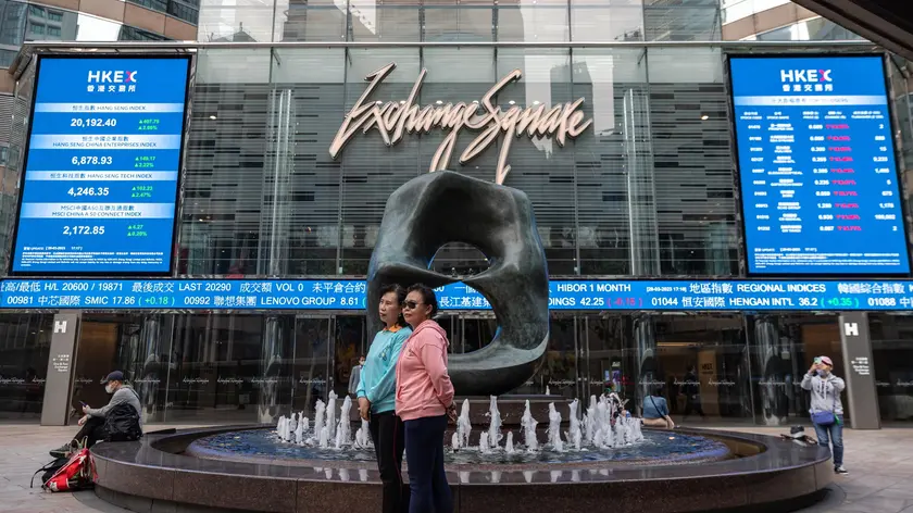 epa10548449 Two mainland Chinese women pose for photos outside Exchange Square, the building housing the stock market, in Hong Kong, China, 29 March 2023. The Hang Seng Index jumped 2.1 per cent to 20,192.40 as Alibaba Group Holding rallied in Chinese technology companies after the company unveiled a business reorganisation to boost profits and add value to shareholders. EPA/JEROME FAVRE