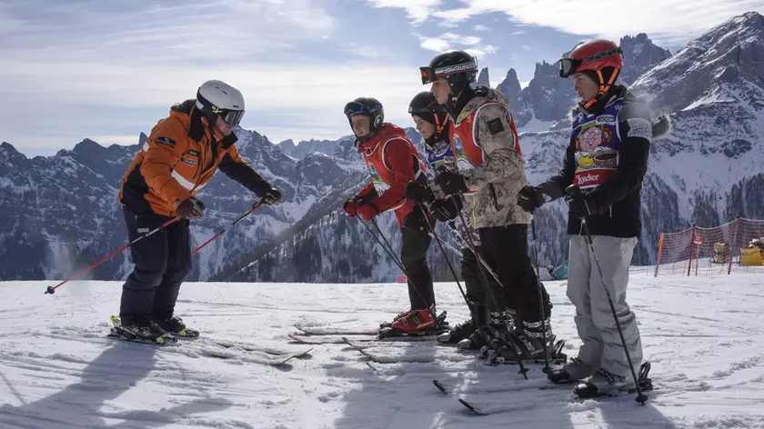 Un maestro di sci con un gruppo di allievi