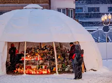 Fiori e candele lasciati in omaggio alle vittime di Crans-Montana (foto Epa)