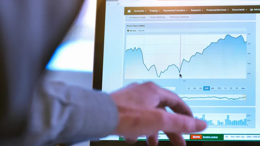 Investor viewing company share price market data on a laptop computer