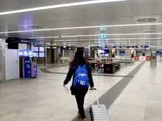 One of the last departing passengers walks inside Milan's Linate cityairport which is semi-deserted due to the coronavirus emergency, MIlan, Italy, 13 March 2020. One of the last departing passengers walks inside Milan's Linate airport which is semi-deserted due to the coronavirus emergency. the entire Milan Linate airport was temporarily closed. In order to minimize the number of people involved in operational activities to protect the health of all and according to the provisions of the Decree issued today by the Ministry of Transport, commercial and general aviation passenger traffic will be concentrated on Milan Malpensa airport. ANSA/Mourad Balti Touati