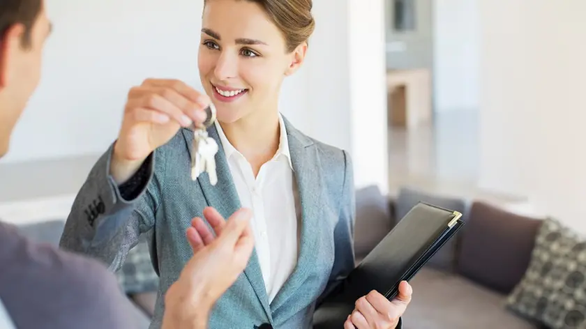 Realtor giving man keys to new house