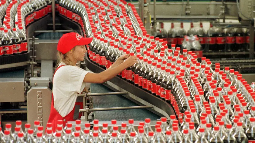 FILE - Sarina Krause checks bottles at the production line of the Coca-Cola plant in Genshagen, eastern Germany, in this Sept. 15, 1999 file picture. Jack L. Stahl, Coca-Cola's president and chief operating officer, resigned Sunday March 4, 2001 as the beverage giant announced a reorganization of its management structure. (AP Photo/Sven Kaestner)