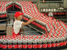 FILE - Sarina Krause checks bottles at the production line of the Coca-Cola plant in Genshagen, eastern Germany, in this Sept. 15, 1999 file picture. Jack L. Stahl, Coca-Cola's president and chief operating officer, resigned Sunday March 4, 2001 as the beverage giant announced a reorganization of its management structure. (AP Photo/Sven Kaestner)