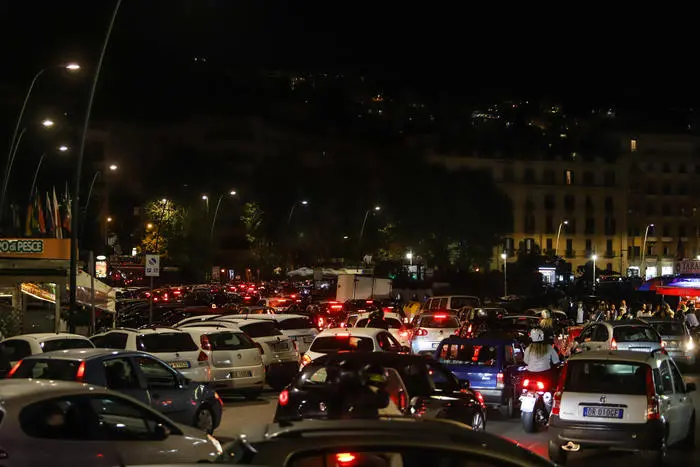 People gather by car on the waterfront to enjoy night life during phase 2 of the coronavirus emergency, in Naples, southern Italy, 24 May 2020. Traffic blocked until 4 in the morning, gatherings and bivouacs, shouts, fights between young people and exasperated residents. Who was on the Naples waterfront last night for the first Saturday post lockdown speaks of "collective madness". Thousands of people, even without a mask, poured into the street, on foot or by car, with the sidewalks used as preferential lanes for cars and motorcycles, despite the nightlife venues have respected the closing time at 11pm. ANSA/ CESARE ABBATE
