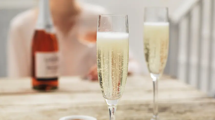 Prosecco in two glasses on a wooden table