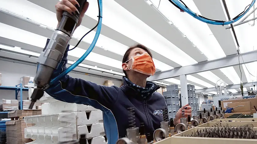 A worker of the Polini company at work wearing a protective mask, Alzano Lombardo, Bergamo, 06 March 2020. The factory is located in Alzano Lombardo one of the villages in the province of Bergamo which risks becoming "red zone" due to the spread of Coronavirus.. According to official figures the number of Coronavirus cases in Italy, the center of Europe's COVID-19 outbreak, was at 3,858 cases by 06 March with a death toll of 148 people while 414 people have recovered since the outbreak. ANSA/MATTEO BAZZI