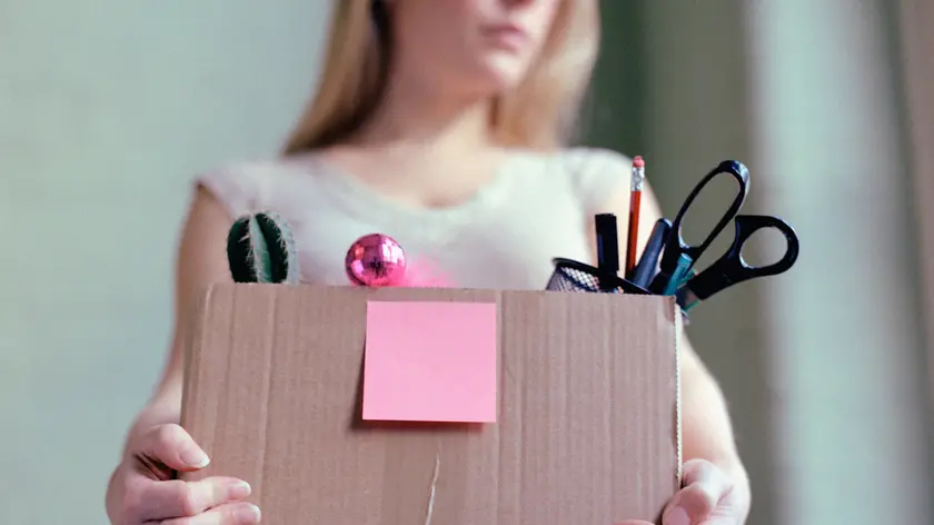 Woman carrying box of stationery