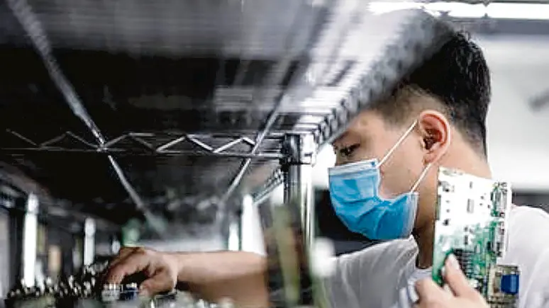 epa08296711 A man works in the VDWALL factory in Shenzhen, Guangdong province, China, 13 March 2020 (issued 16 March 2020). China's value-added industrial output, an important economic indicator, fell 13.5 percent year-on-year in the first two months of 2020 as the coronavirus outbreak hurt activities, according to a report issued by the National Bureau of Statistics on 16 March 2020. VDWALL is a high-tech enterprise specializing in developing and manufacturing video processing equipment for LED displays. EPA/ALEX PLAVEVSKI