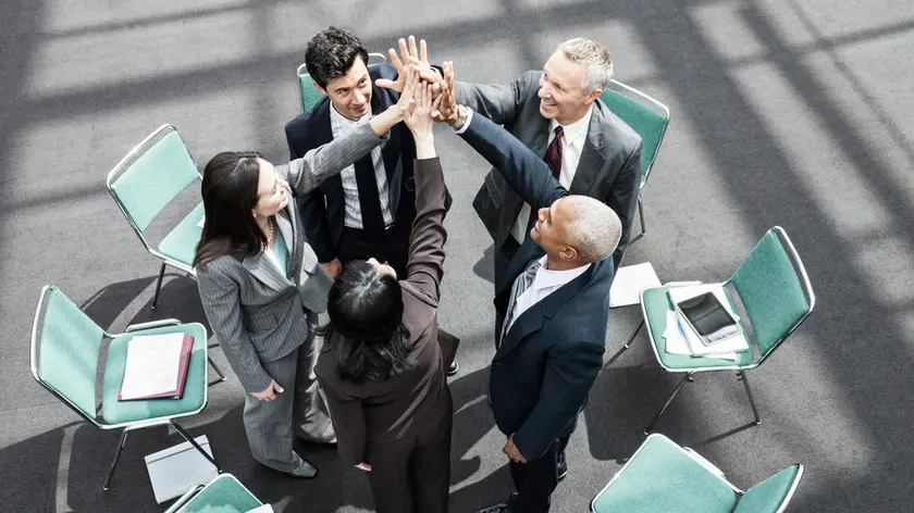 Mixed race group of business people in an informal team building meeting.