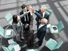 Mixed race group of business people in an informal team building meeting.