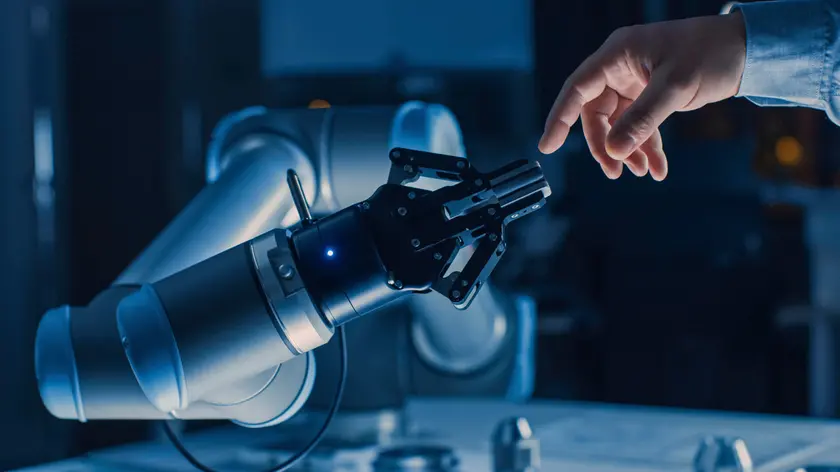Robotic arm touching a human hand