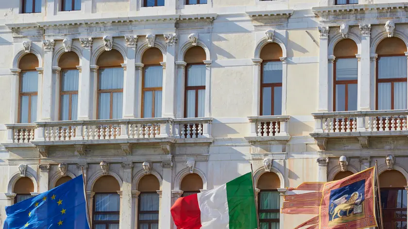 Flags of the European union, Italy and the Venetian flag flying on the Palazzo Ferro Fini, Venice, Veneto, Italy, Europe.