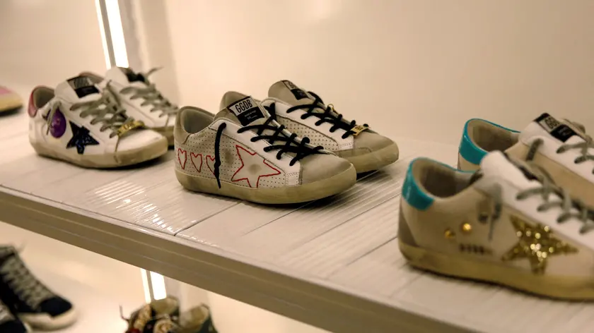 FILE PHOTO: Sneakers of Italian high fashion sneaker brand Golden Goose are displayed at its store in Beijing, China September 23, 2020. Picture taken September 23, 2020. REUTERS/Tingshu Wang/File Photo