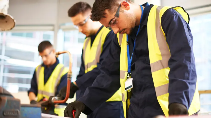 Focused male students in shop class workshop