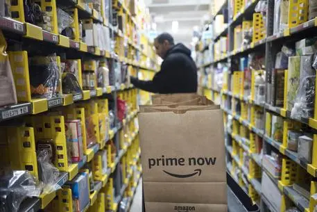 FILE - In this Wednesday, Dec. 20, 2017, file photo, a clerk reaches to a shelf to pick an item for a customer order at the Amazon Prime warehouse, in New York. Amazon announced Thursday, Jan. 18, 2018, that it has narrowed down its potential site for a second headquarters in North America to 20 metropolitan areas, mainly on the East Coast. (ANSA/AP Photo/Mark Lennihan, File) [CopyrightNotice: Copyright 2017 The Associated Press. All rights reserved.]